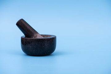 Mortar and pestle on isolated blue background
