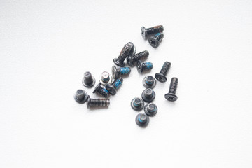 A group of bolts lying on the center of a gray background close-up