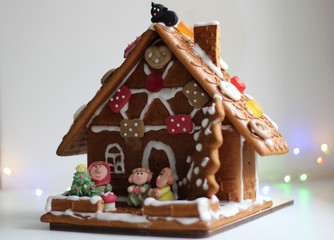 Beautiful decorated gingerbread house with various figures. On white background