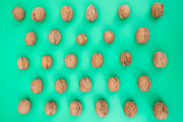 raw walnuts top view photo, background is green