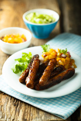 Fried sausages with fruit salsa