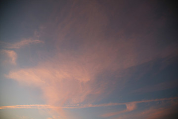 Sky background beautiful image. Abstract background is decorated with different types of clouds. Sunset in the evening sky. The sun  rays illuminate the clouds.