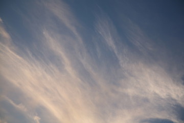Obraz premium The bright background of the sky is covered with beautiful clouds. Very light clouds and sky soar across the horizon. Wind accelerates paint with a blue background image of nature.