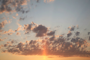 Fototapeta premium Sky clouds as the best picture. The most abstract background image of the sky. Beautiful sunset. The sun rays illuminate the clouds.