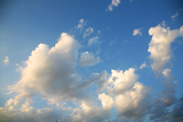 The bright background of the sky is covered with beautiful clouds. Very light clouds and sky soar across the horizon. Wind accelerates paint with a blue background image of nature.