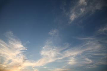 The bright background of the sky is covered with beautiful clouds. Very light clouds and sky soar across the horizon. Wind accelerates paint with a blue background image of nature.
