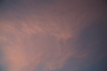 The sun  rays illuminate the sky with clouds. We see the background of the sky of natural color as in the picture. This image of a beautiful sky and white clouds pleases all people.