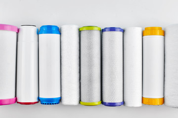 Water filters. Carbon cartridges on a white background. Household filtration system.