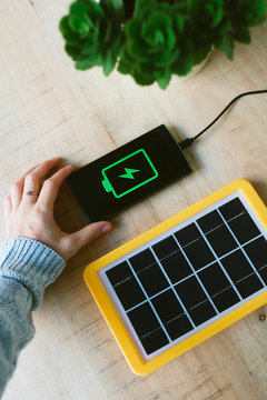 Renewable energy technology, solar panel charging a mobile phone battery