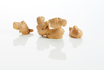 Ginger roots on white ground