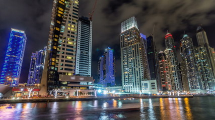 View of Dubai Marina Towers and canal in Dubai night timelapse hyperlapse