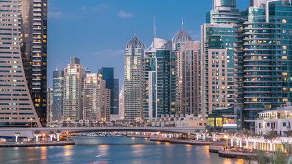 Fototapeta na wymiar View of Dubai Marina Towers and canal in Dubai day to night timelapse