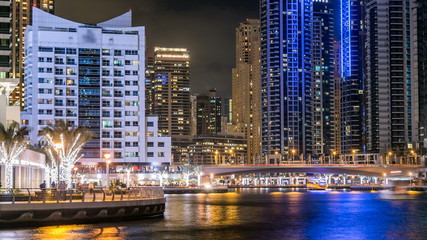 Naklejka premium View of Dubai Marina Towers and canal in Dubai night timelapse