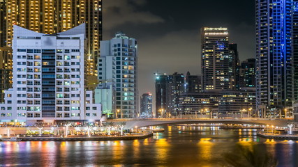 Obraz premium View of Dubai Marina Towers and canal in Dubai night timelapse