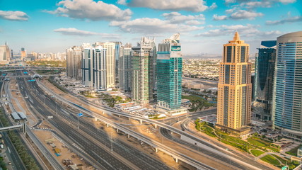 Fototapeta na wymiar Aerial view of Dubai marina skyscrapers and Jumeirah lakes towers timelapse with traffic on sheikh zayed road.