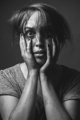 Scared girl  with smeared make up. Black and white. Low key
