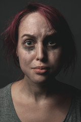 frightened woman with smeared make up.