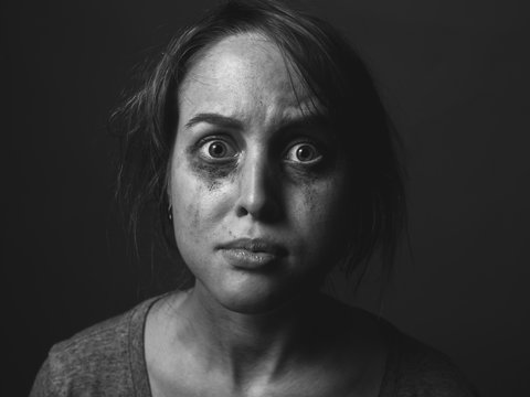Frightened woman with smeared make up.