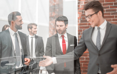 background image of a group of business people standing in the office