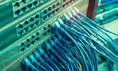 network cables and hub closeup with fiber optical background