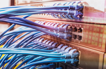 network cables and hub closeup with fiber optical background