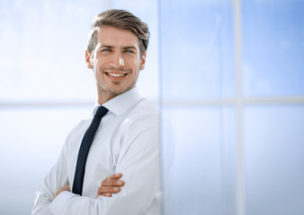 Fototapeta premium smiling businessman standing near the office window