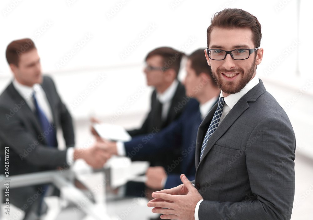 Sticker smiling businessman on blurred office background