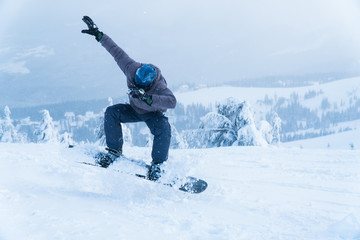 Fototapeta na wymiar male snowboarding snowboard jump. go in the mountains on Snow Mountain winter snowboarding.