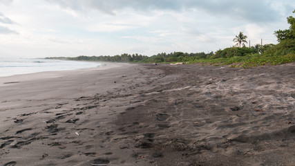 dark beach with clouds and fog