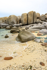 Fototapeta na wymiar Stones on the sandy shore