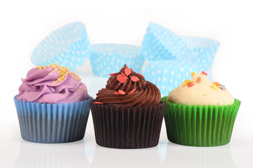 assorted delicious cupcakes on isolated background
