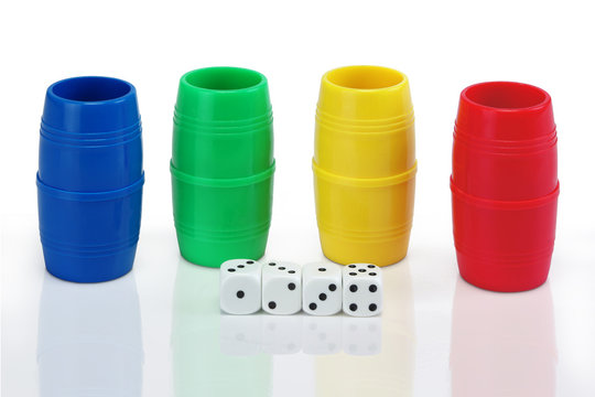 four shaker of different colors and dices