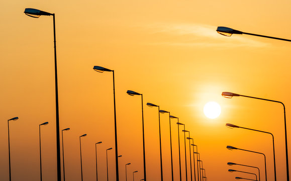 Street lamp poles and beautiful sunset sky. - Powered by Adobe