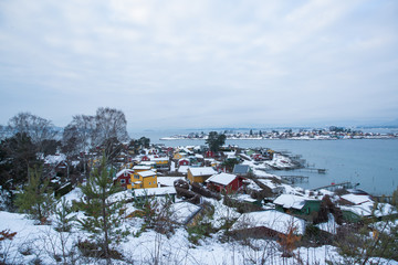 Traditional cottages on the islands around Oslo Norway during the winter overlooking the sea and the Fjord in snow condition