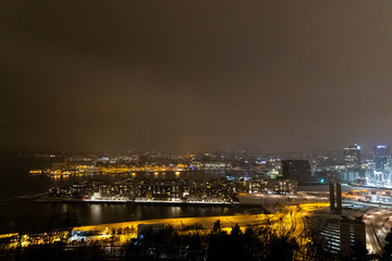Fototapeta na wymiar Overlooking the city center of Oslo Norway during the winter all covered with fresh snow during the evening time