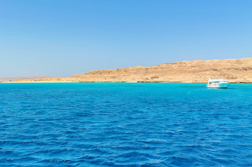 Fototapeta premium White yacht on a sunny day on the red sea surrounded by clear blue water