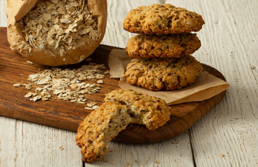 Oatmeal cookies with milk on tray on rustic wooden table