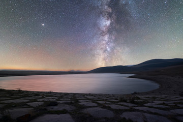 Small lake and milky way galaxy. Beautiful starry night. Armenia