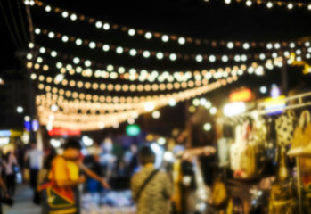 Abstract blurred background of people shopping at night market in the city - Powered by Adobe