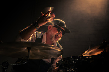The drummer, vigorously playing the drums