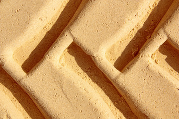 the track of the tractor wheels in the sand