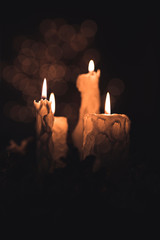 Christmas candles and ornaments over background with lights