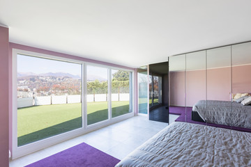 Bedroom overlooking the terrace with grass.