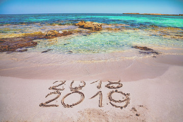 inscription 2018 and 2019 on the beach
