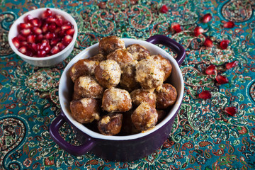 Juicy meat meatballs with dates and pomegranate seeds.
