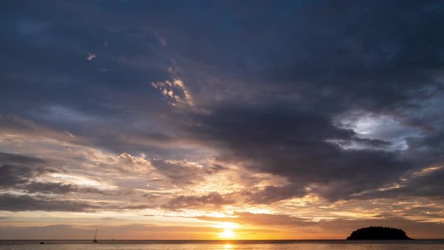Time lapse video Scene of Colorful sunset with Moving clouds at kata beach in phuket thailand. Kata Beach is a great sunset beach which is popular with tourists. in nature and travel concept.