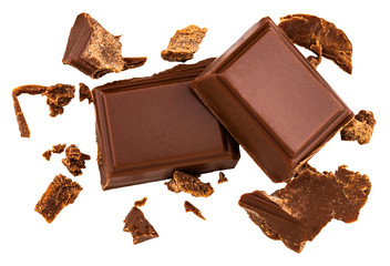 Milk chocolate pieces isolated on white background from top view