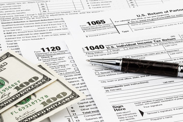 The tax forms with  money and the pen. Tax Day concept
