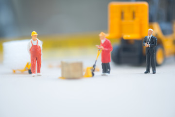 Miniature business man look workers carrying products. Cargo and shipping concept