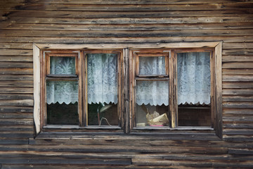 The wooden wall is large with a window in the middle.